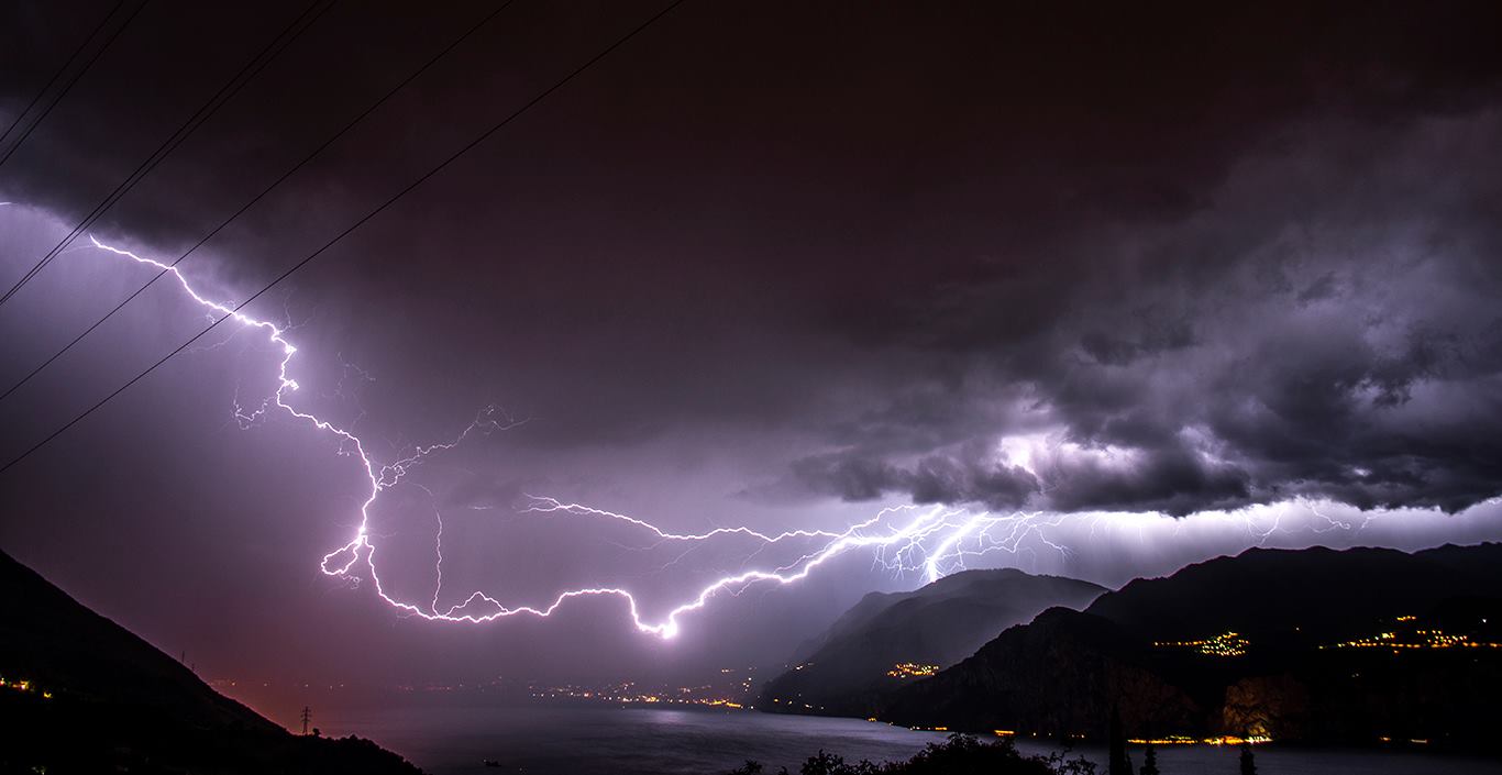 Luglio 2016 - Fulmine sul Lago di Garda, causato da un forte temporale sviluppatosi davanti al fronte freddo. I temporali prefrontali sono molto frequenti sulla zona del Garda – Baldo, trovando nella pianura Padana calda e umida le condizioni ideali per svilupparsi. Foto di Claudio Chincarini.