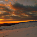 Gennaio 2015 - Nella foto di Cristian Colognato, il tramonto del 25 gennaio da San Giorgio verso Sud-Ovest. Il sole illumina il basso Lago di Garda e l’altipiano della Lessinia, facendosi spazio tra strati nuvolosi. il Monte Baldo, a destra nell’immagine, resta a guardare.